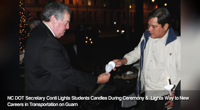 NC DOT Secretary Conti Lights Student's Candle during Tree Lighting Ceremony in Raleigh NC